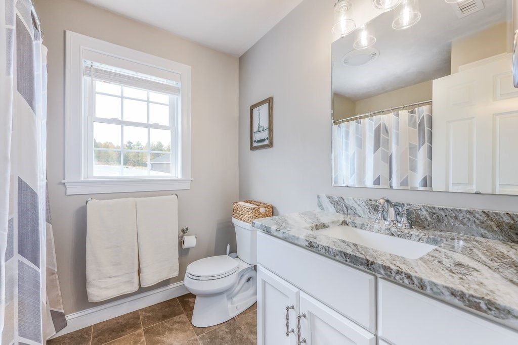 51 Woodside Avenue Rutland, MA 01543 - Photo 23 of 24 a bathroom with a granite countertop sink a toilet and a window