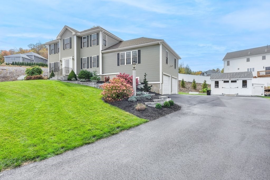 51 Woodside Avenue Rutland, MA 01543 - Photo 3 of 24 a front view of a house with a garden and yard