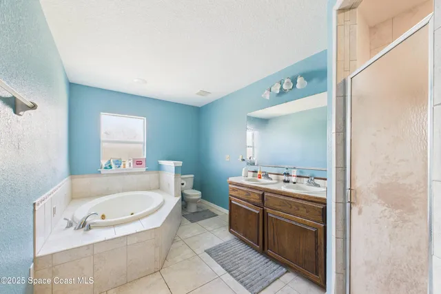 a bathroom with a sink a bathtub and a mirror