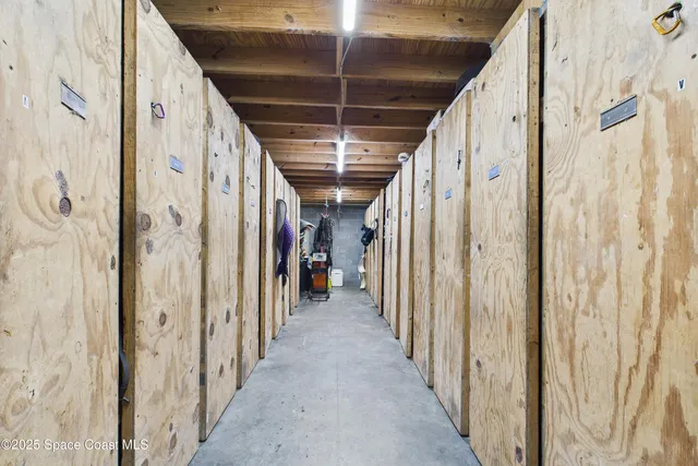 a view of hallway with wooden floor and stairs