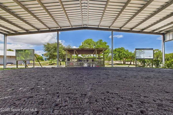 a view of a wooden deck and a big yard