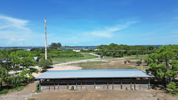 a view of a swimming pool with lawn chairs
