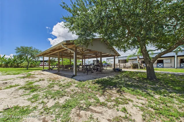 a view of a house with backyard porch and sitting area