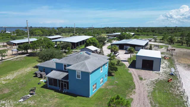 an aerial view of a house with yard swimming pool and outdoor seating