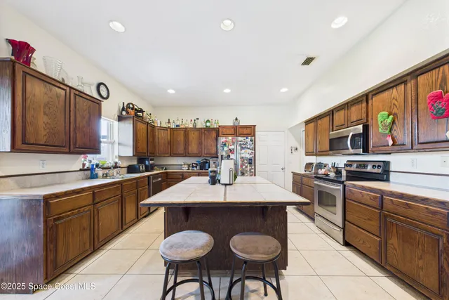 a kitchen with stainless steel appliances a sink stove and cabinets