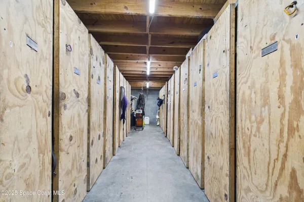 a view of a backyard with table and chairs under an umbrella