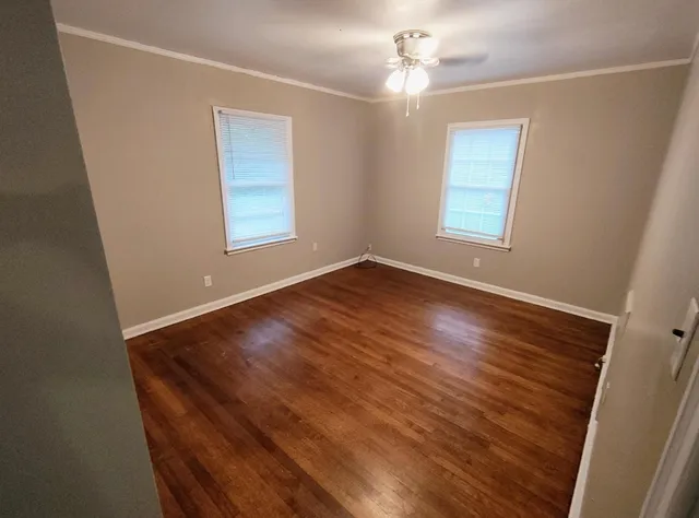 wooden floor in an empty room with a window