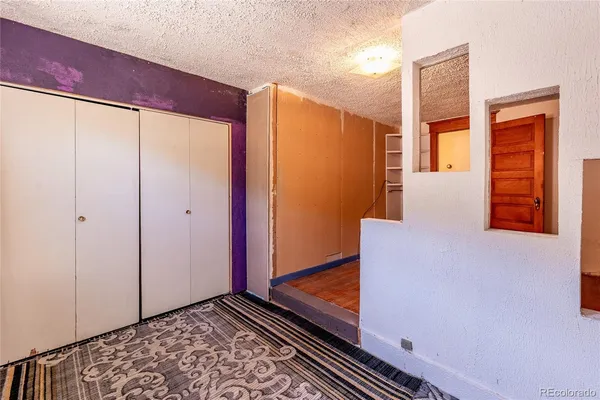 a view of a room with wooden floor and stairs