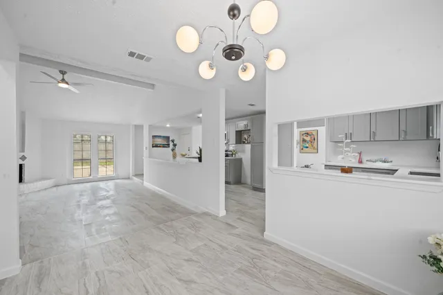 a view of livingroom with kitchen island furniture and wooden floor
