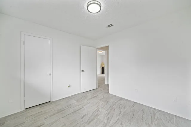 a view of an empty room and wooden floor