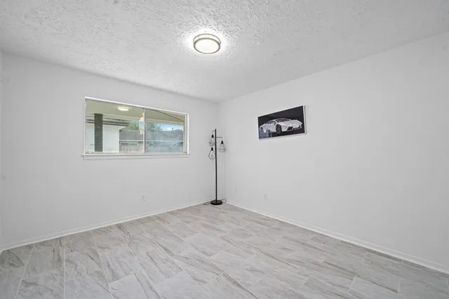 an empty room with windows and closet