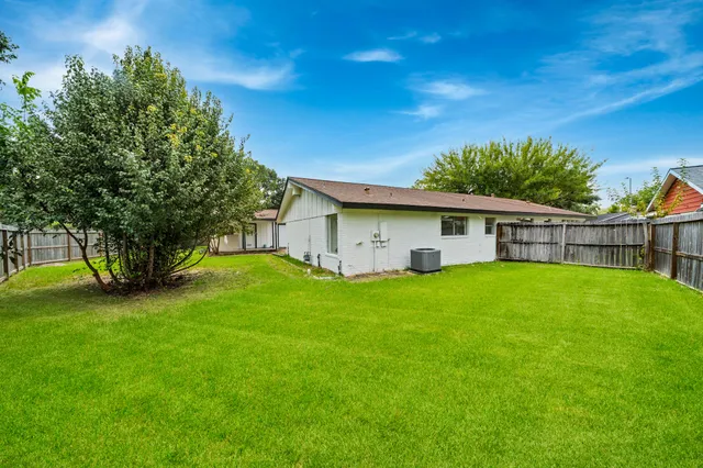 a front view of house with a garden