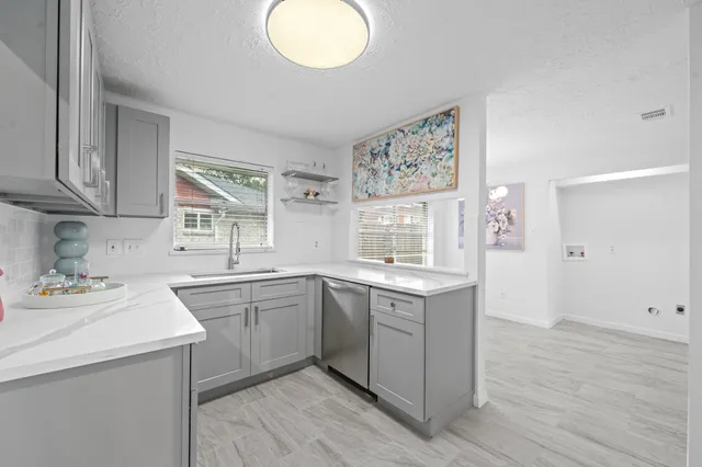 a kitchen with a sink cabinets and window