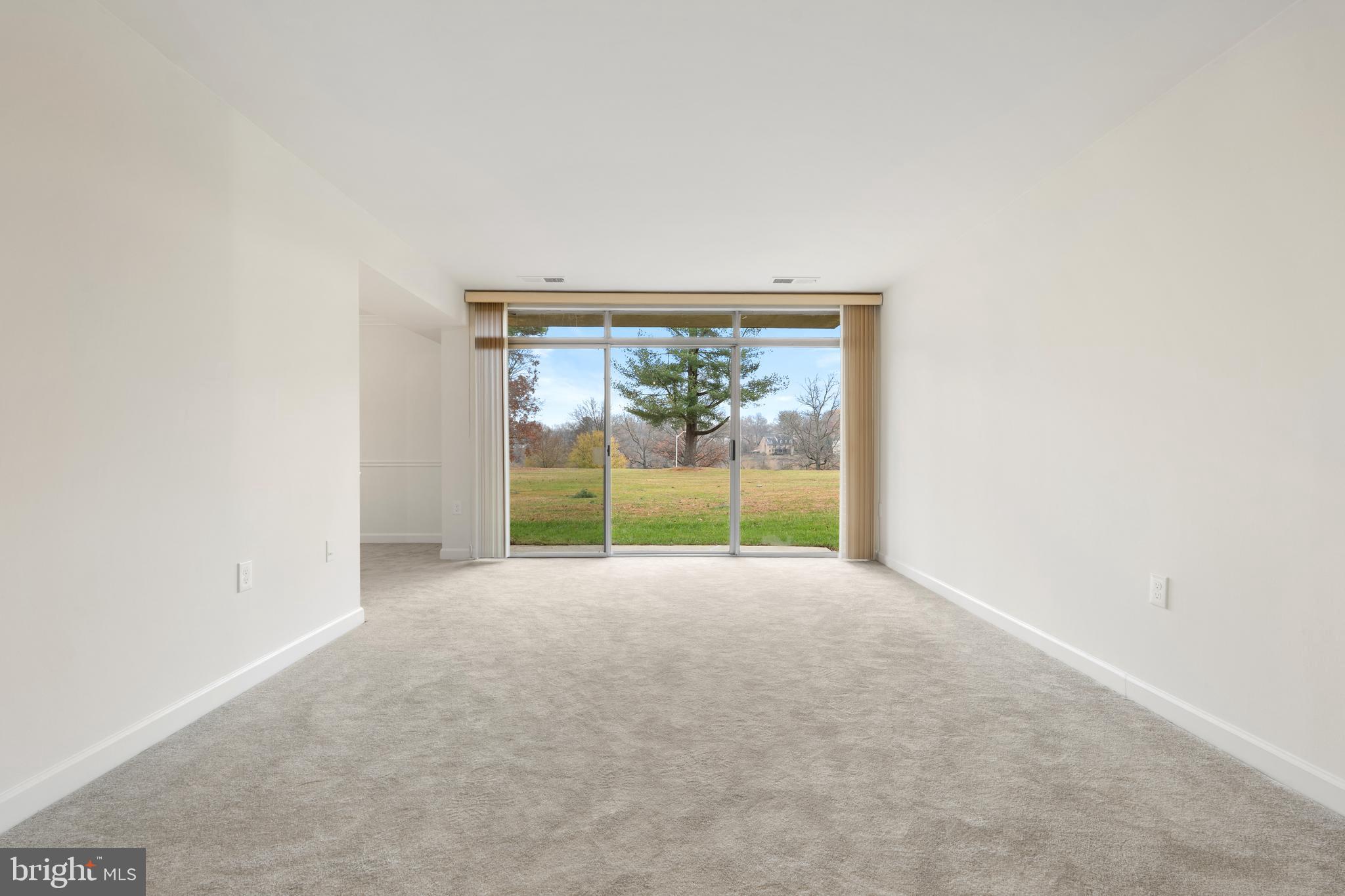 18715 Walkers Choice Road, Unit 18715 Montgomery Village, MD 20886 - Photo 12 of 30 a view of an empty room with a sliding door