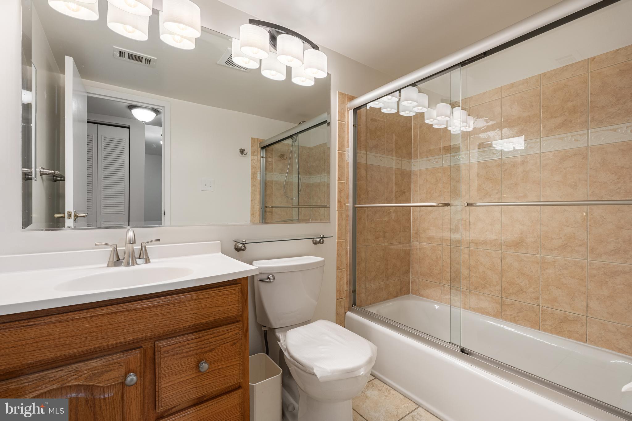 18715 Walkers Choice Road, Unit 18715 Montgomery Village, MD 20886 - Photo 16 of 30 a bathroom with a sink a toilet and shower