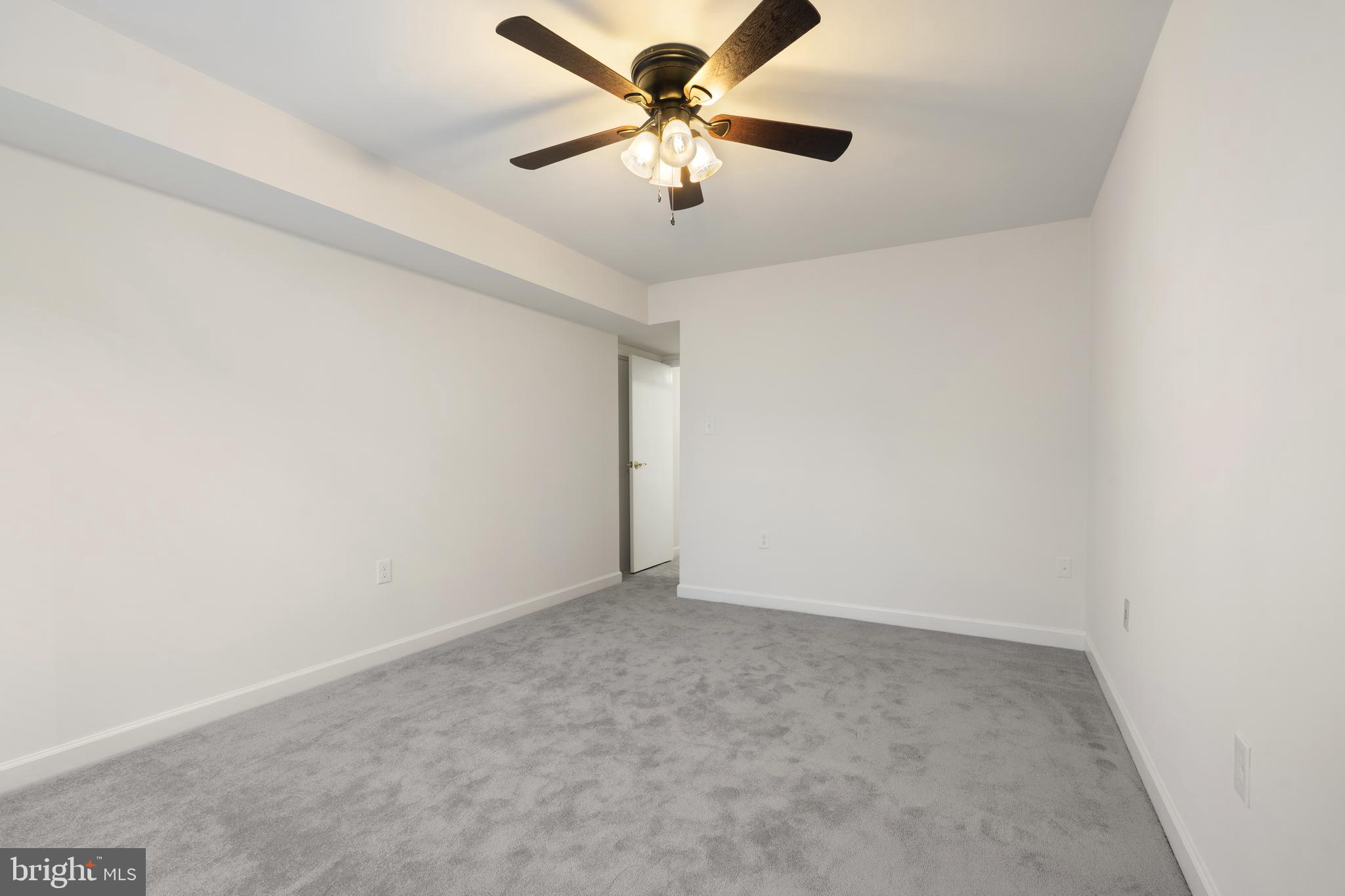 18715 Walkers Choice Road, Unit 18715 Montgomery Village, MD 20886 - Photo 22 of 30 an empty room with a fan and a ceiling fan
