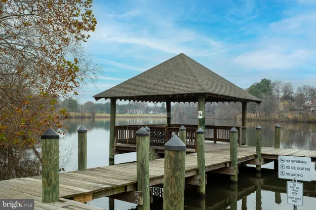 a roof deck with table and chairs under an umbrella