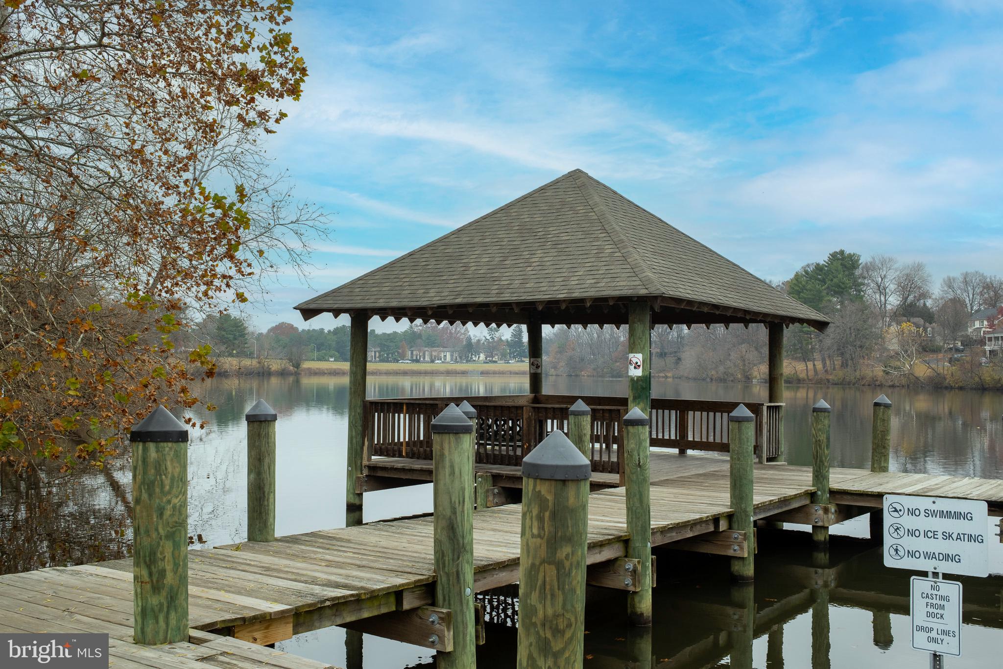 18715 Walkers Choice Road, Unit 18715 Montgomery Village, MD 20886 - Photo 29 of 30 a roof deck with table and chairs under an umbrella