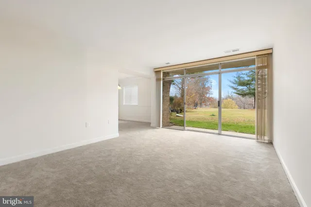a view of an empty room with glass door