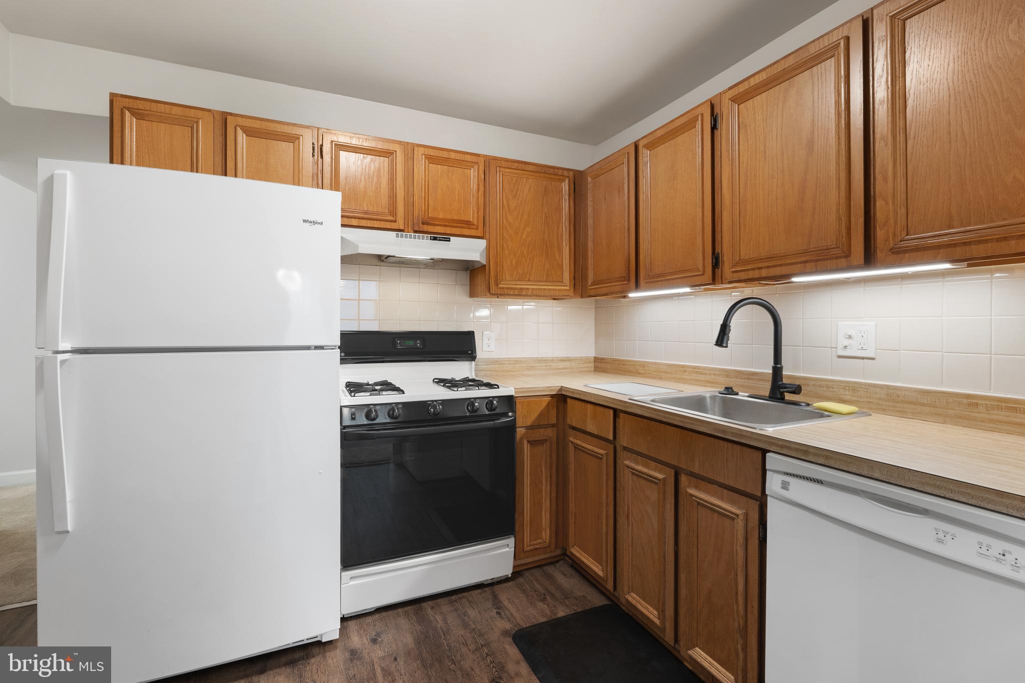 18715 Walkers Choice Road, Unit 18715 Montgomery Village, MD 20886 - Photo 8 of 30 a kitchen with stainless steel appliances granite countertop a refrigerator sink and cabinets