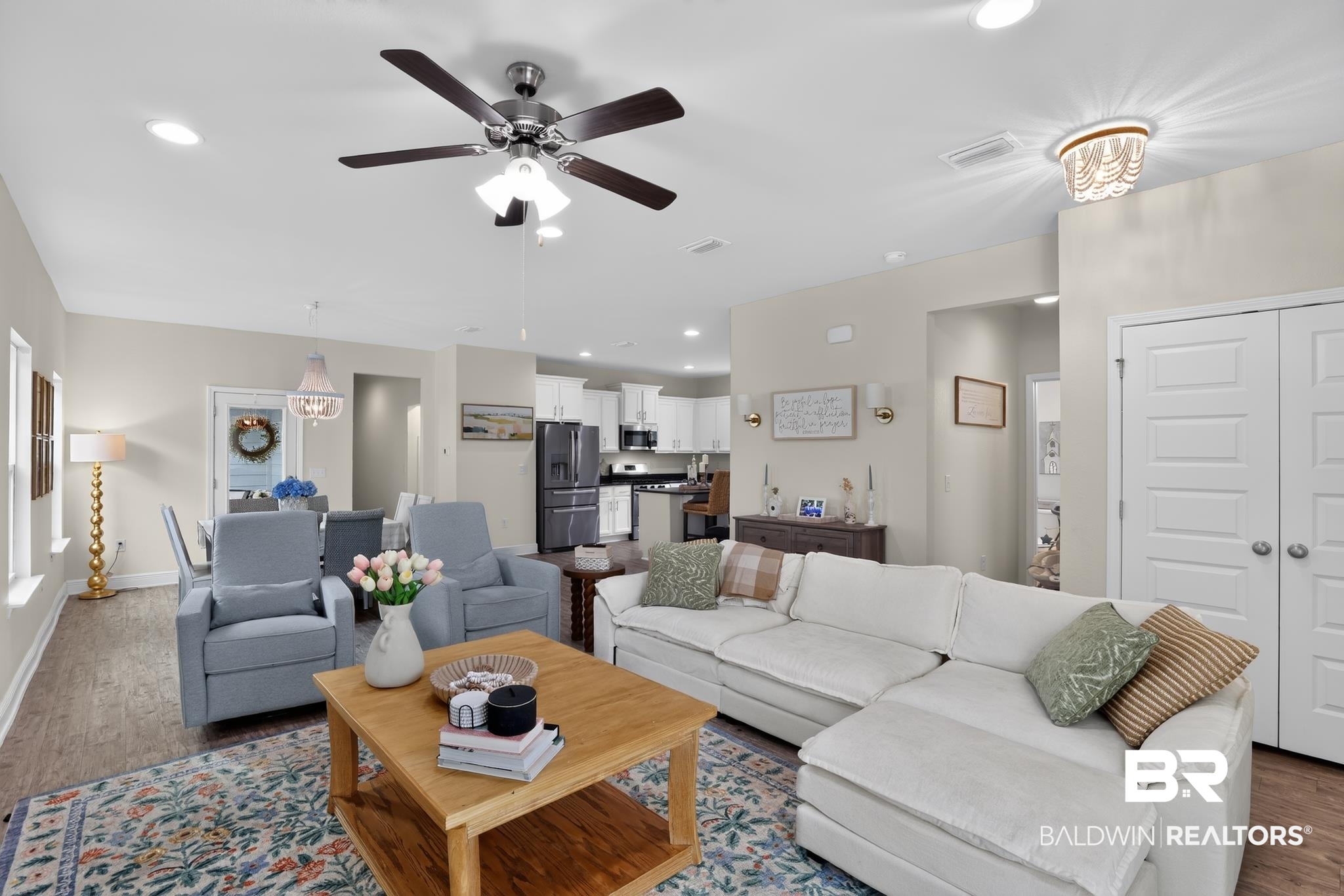 1210 Primrose Lane Foley, AL 36535 - Photo 8 of 33 Open-concept living area featuring wood-finish flooring, a ceiling fan with integrated lighting, recessed lighting, and a dining area with a decorative chandelier