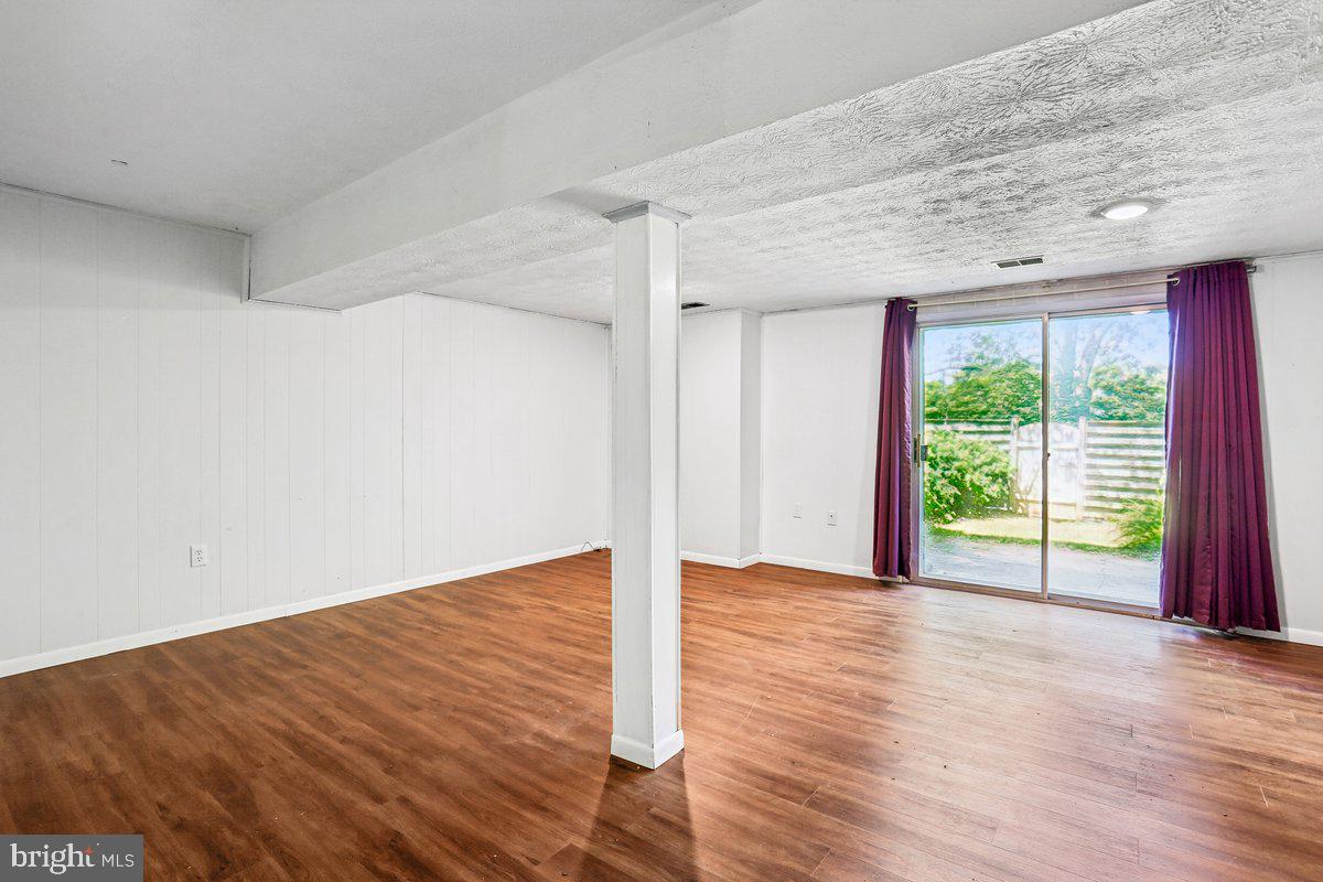 76 Timber Rock Road Gaithersburg, MD 20878 - Photo 37 of 51 a view of an empty room with wooden floor and a window