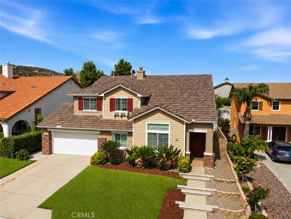 152 Alabaster Loop Perris, CA 92570 - Photo 1 of 29 a front view of a house with a garden and yard