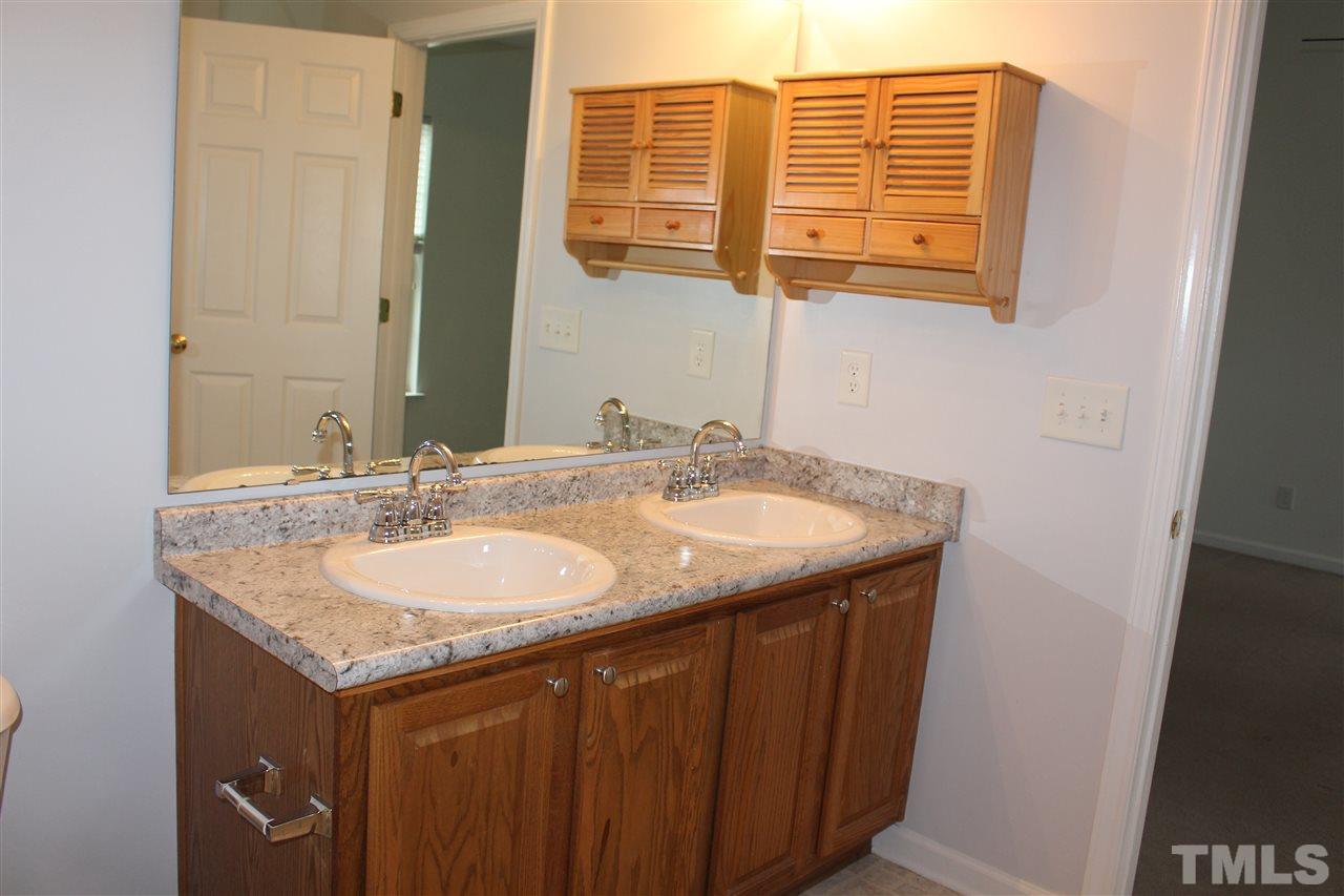 5321 Neuse Forest Road Raleigh, NC 27616 - Photo 13 of 25 a bathroom with a granite countertop sink and a mirror