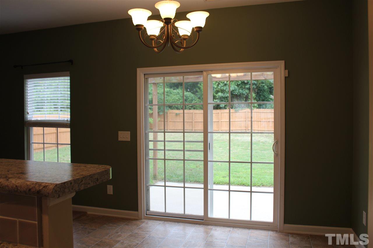 5321 Neuse Forest Road Raleigh, NC 27616 - Photo 23 of 25 a dining room with chandelier and wooden floor