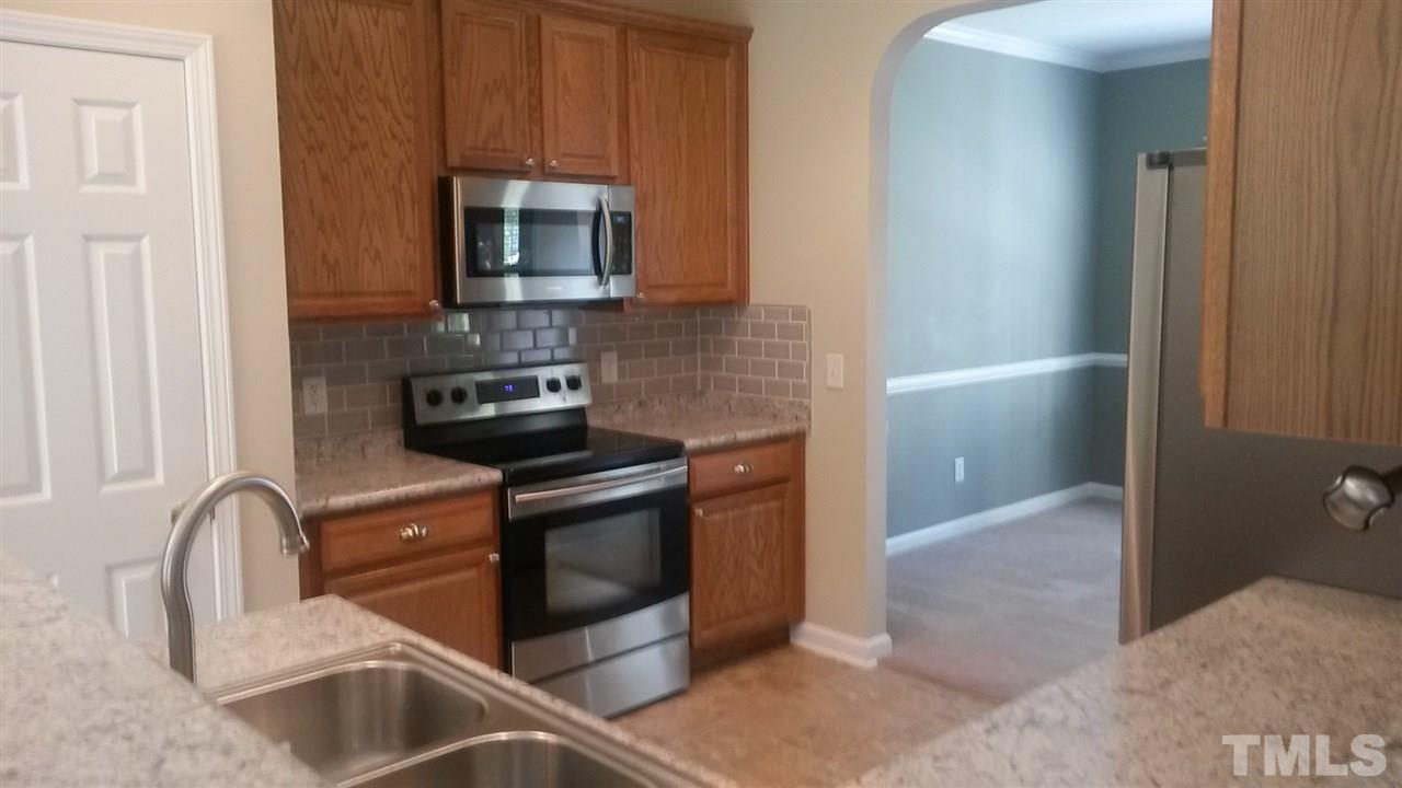5321 Neuse Forest Road Raleigh, NC 27616 - Photo 6 of 25 a kitchen with stainless steel appliances granite countertop a stove a microwave and a sink