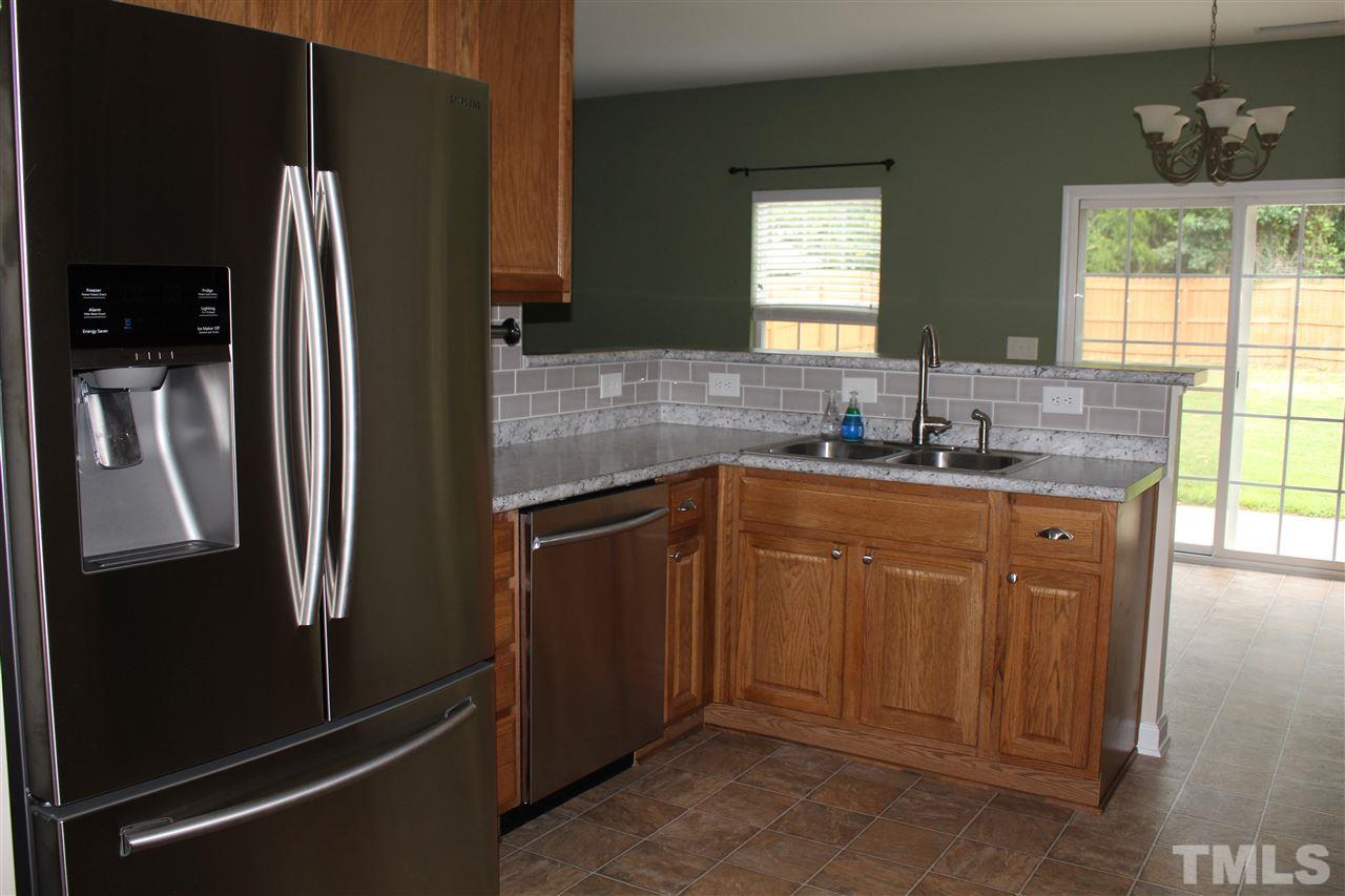 5321 Neuse Forest Road Raleigh, NC 27616 - Photo 7 of 25 a kitchen with stainless steel appliances granite countertop a refrigerator and a sink
