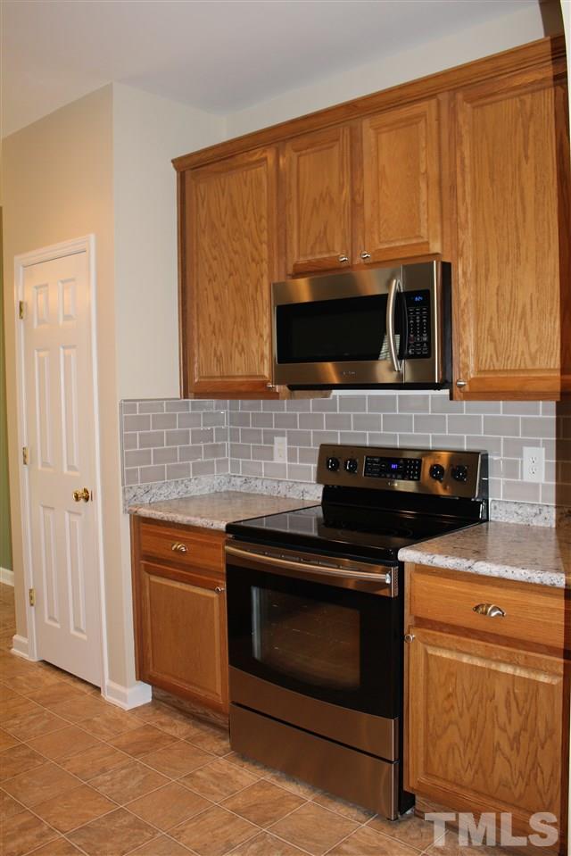 5321 Neuse Forest Road Raleigh, NC 27616 - Photo 8 of 25 a kitchen with microwave stove and cabinets