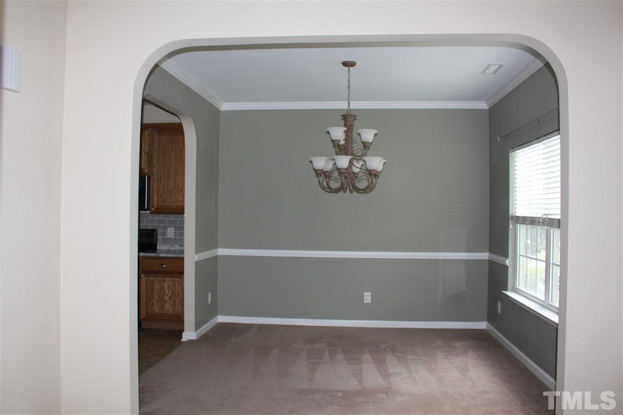 5321 Neuse Forest Road Raleigh, NC 27616 - Photo 10 of 25 an empty room with chandelier fan and windows