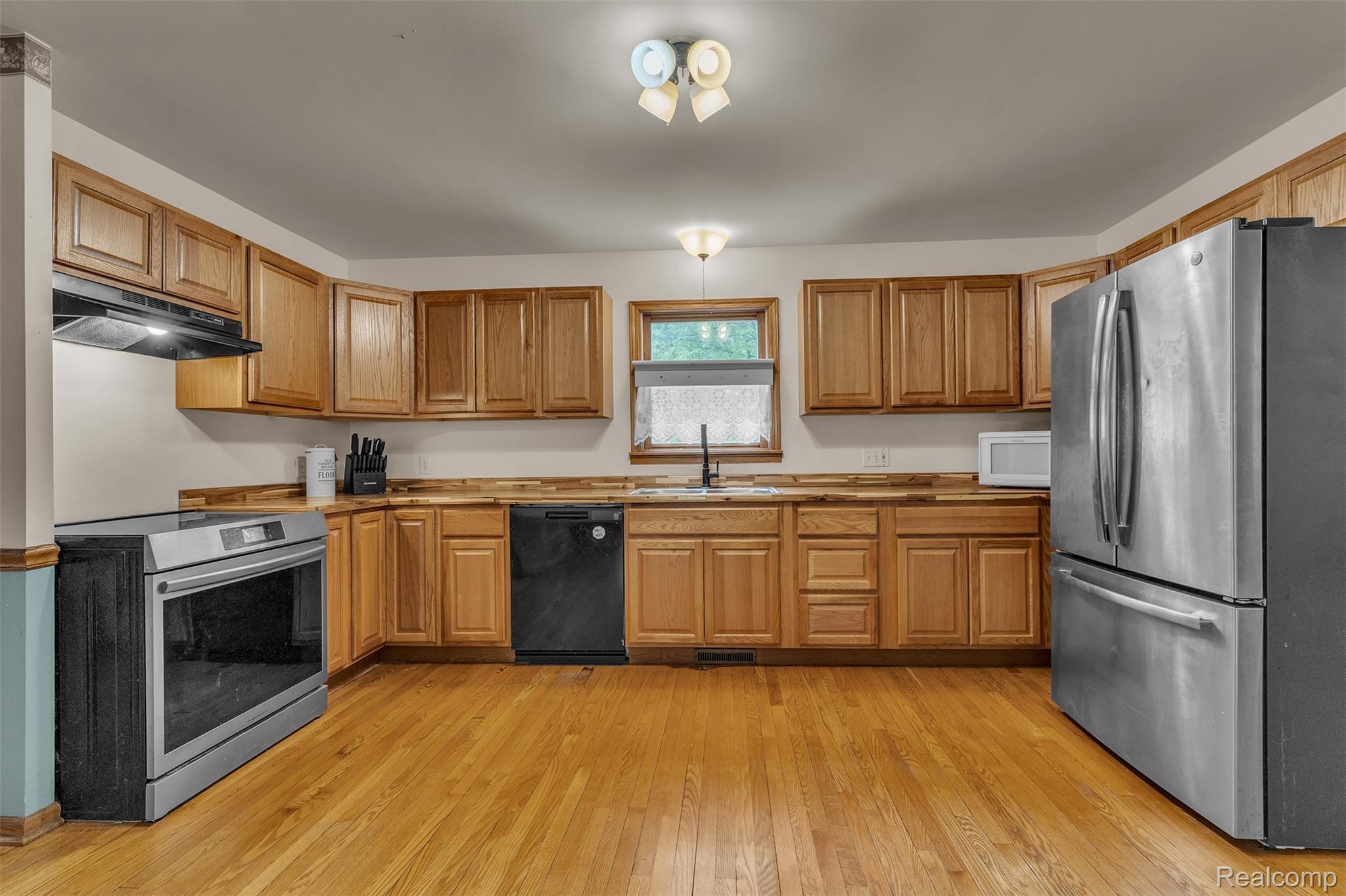1345 Ives Road Mason, MI 48854 - Photo 20 of 92 Kitchen with stainless steel appliances, light wood-style floors, and wood finish cabinets