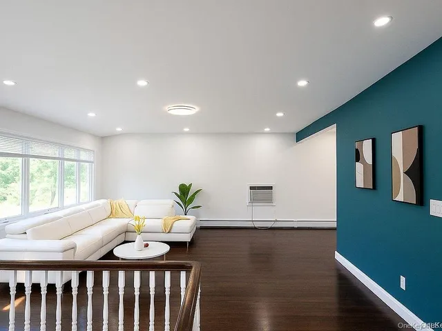 a living room with kitchen island furniture and a wooden floor