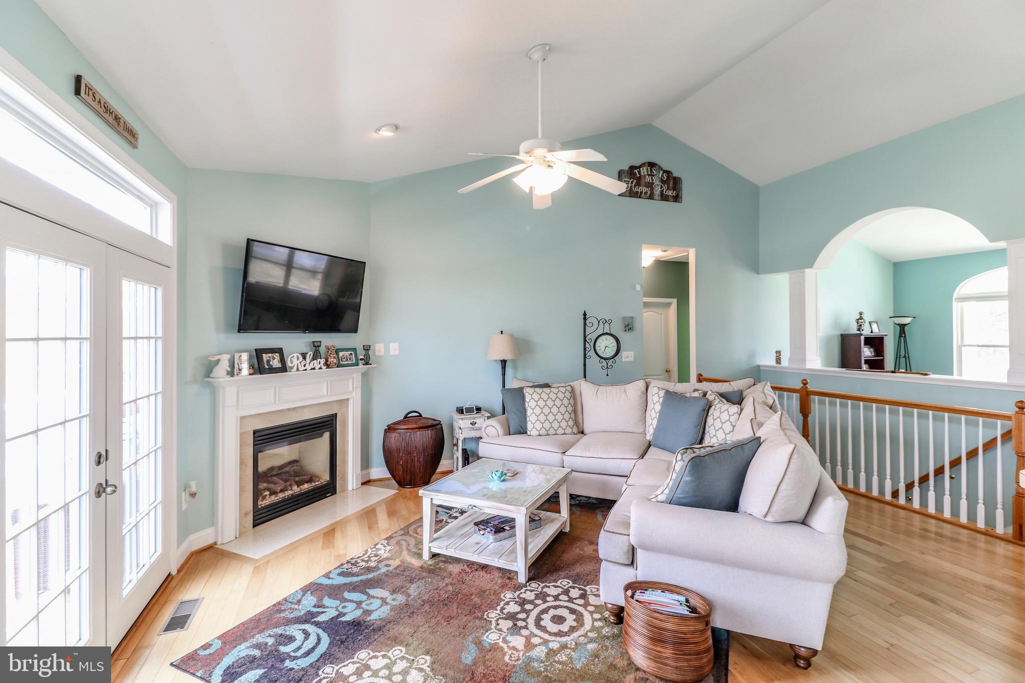 11151 Rawhide Road Lusby, MD 20657 - Photo 6 of 35 Gas fireplace wood floors in family room