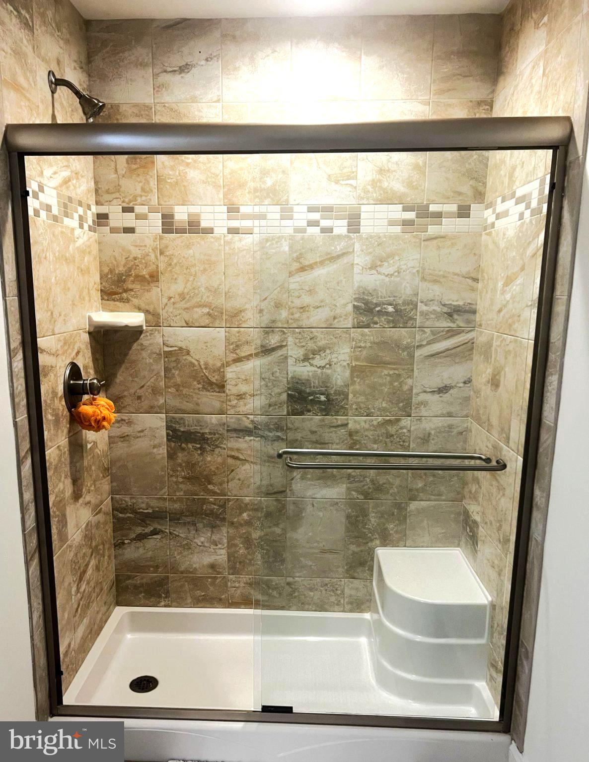 10693 Harding Road Laurel, MD 20723 - Photo 32 of 55 Sleek modern shower with elegant tiles.