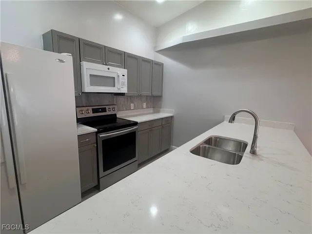 a kitchen with a refrigerator sink and stove