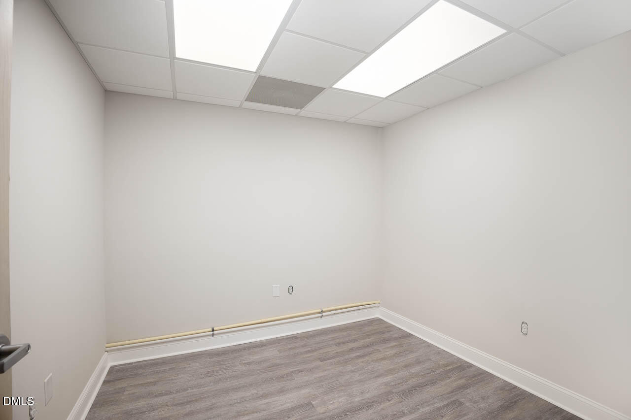 5621 Departure Drive, Unit 101 Raleigh, NC 27616 - Photo 12 of 17 a view of an empty room with wooden floor