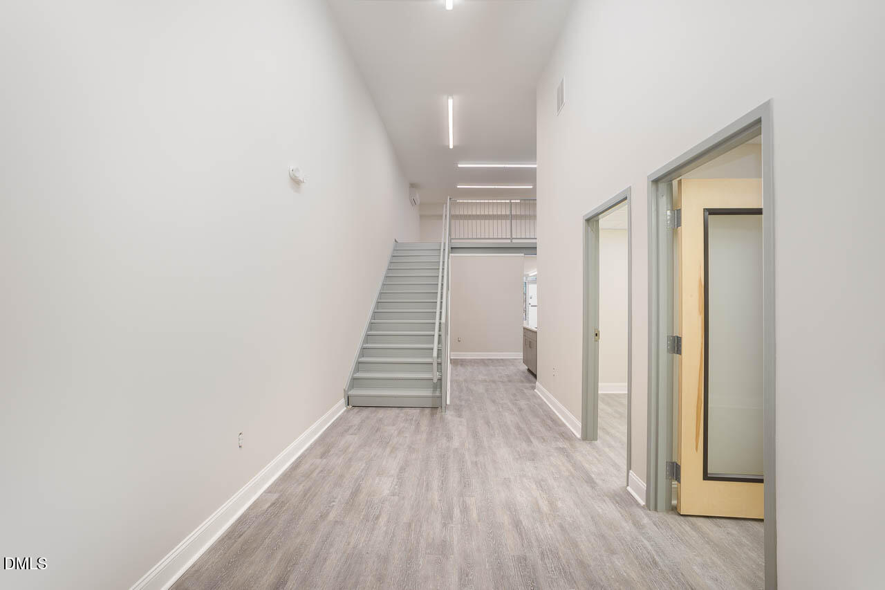 5621 Departure Drive, Unit 101 Raleigh, NC 27616 - Photo 13 of 17 a view of a hallway with wooden floor and entryway
