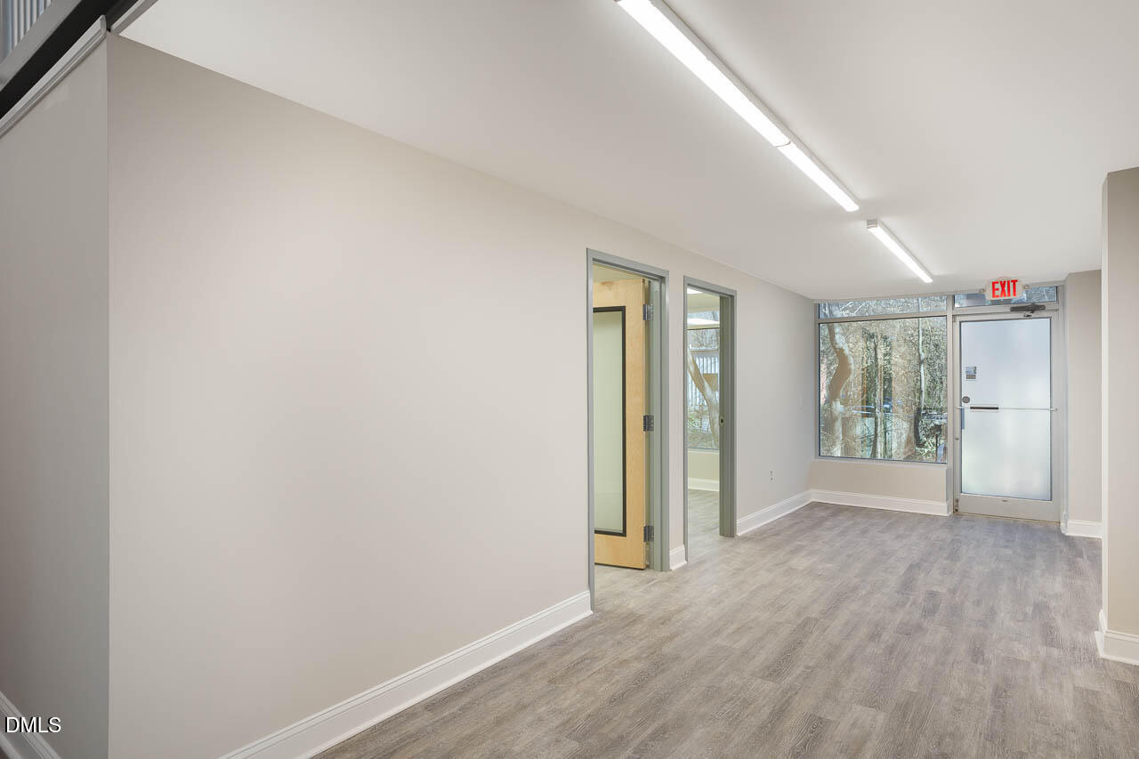 5621 Departure Drive, Unit 101 Raleigh, NC 27616 - Photo 6 of 17 a view of an empty room with wooden floor and a window