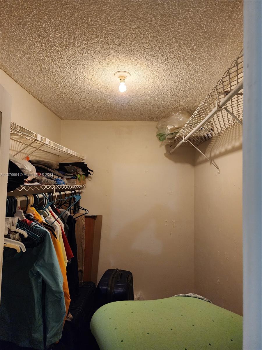 Inverrary Lauderhill, FL 33319 - Photo 4 of 11 a view of walk in closet with clothes and shoes