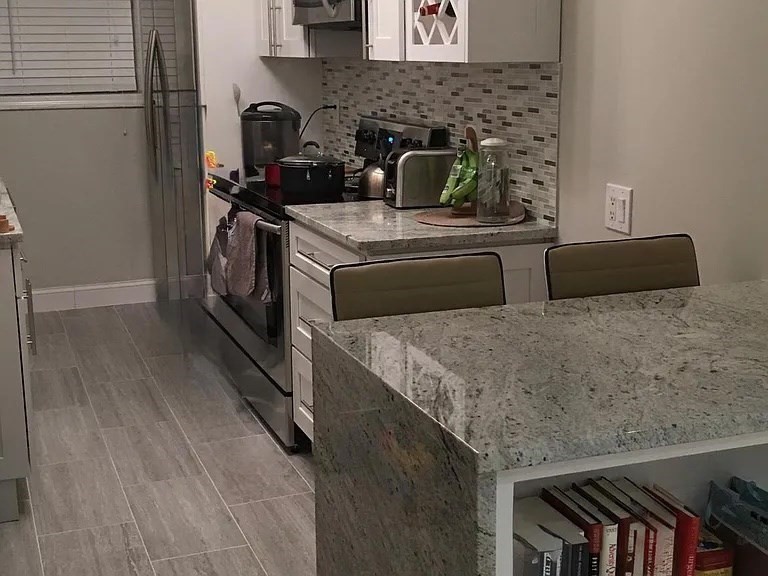 152 Newton Street, Unit 6 Boston, MA 02135 - Photo 2 of 17 a kitchen with stainless steel appliances granite countertop a stove a sink and a refrigerator