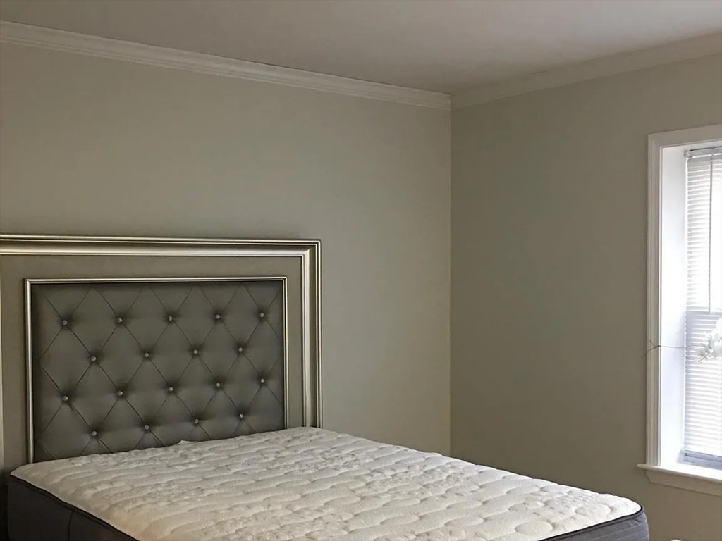 152 Newton Street, Unit 6 Boston, MA 02135 - Photo 4 of 17 a bedroom with a bed and a window