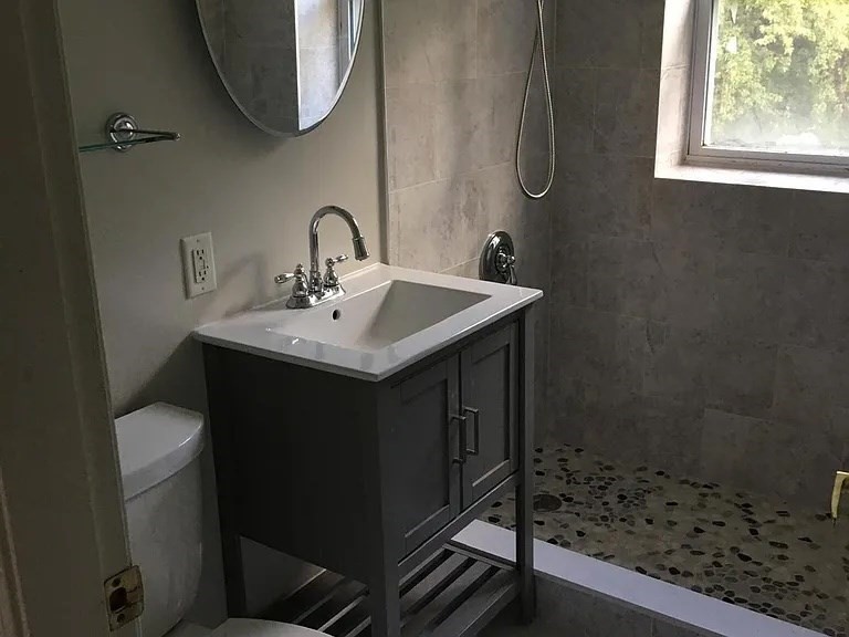 152 Newton Street, Unit 6 Boston, MA 02135 - Photo 8 of 17 a bathroom with a sink a toilet and shower