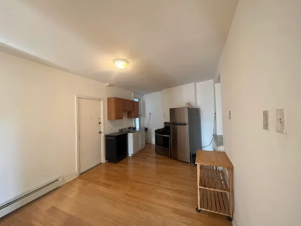 a kitchen with stainless steel appliances a refrigerator and a stove top oven