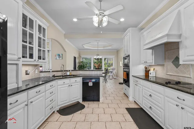 a large kitchen with stainless steel appliances lots of counter space cabinets and a sink