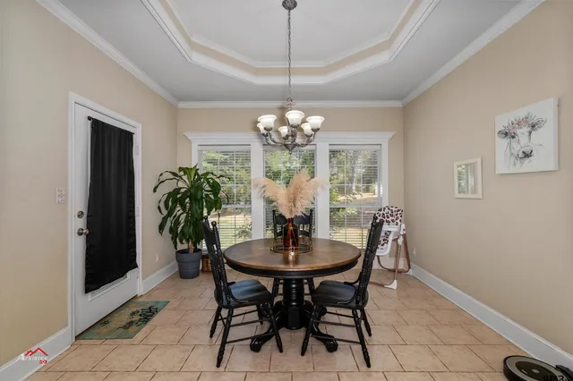a dining room with furniture and chandelier