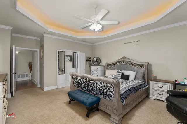 a living room with furniture and a ceiling fan