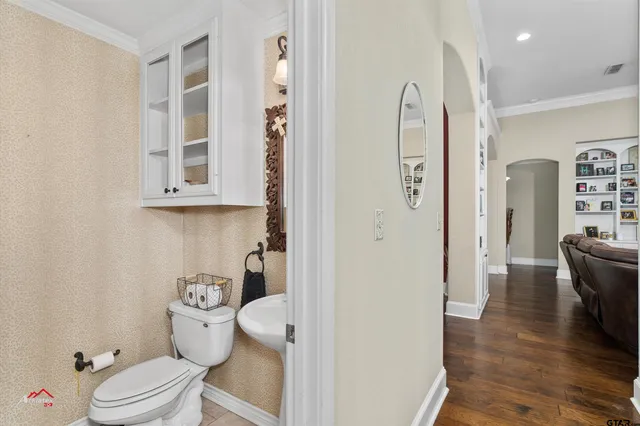 a bathroom with a toilet a sink and shower